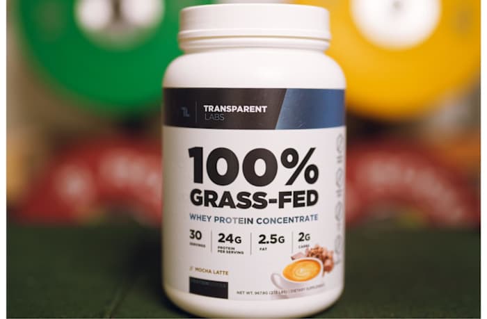 A white and black 2-pound container of Transparent Labs Grass Fed Whey protein powder in Mocha Latte flavor